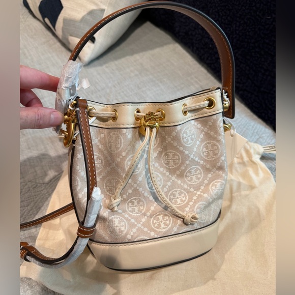 Tory Burch Handbags - Tory Burch new NWT and bag. mini bucket bag beige canvas and tan leather strap